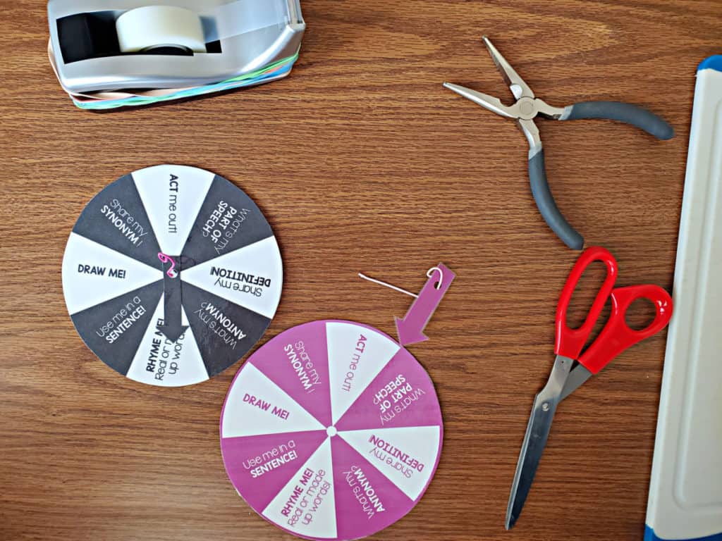 black and purple word wheels with pliers, scissors and tape