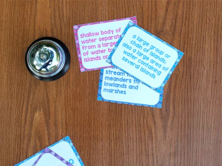 clue cards lying on a desk with a bell